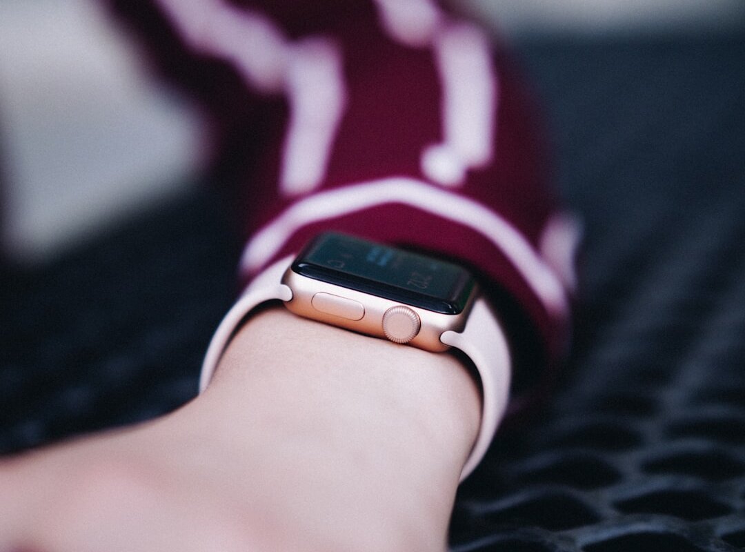 person wearing gold Apple Watch